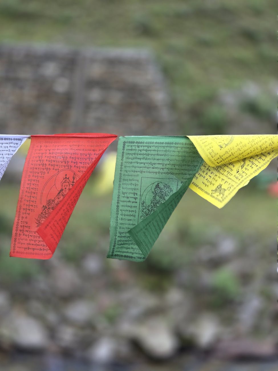 colorful tibetan prayer flags in mountain setting